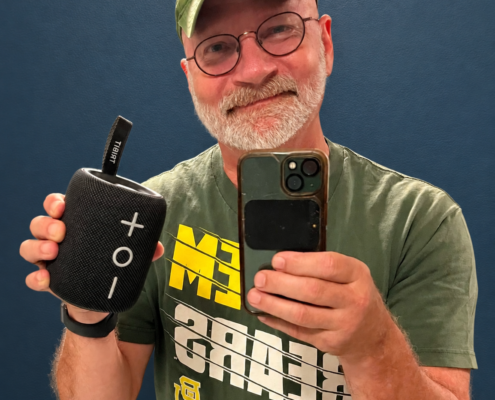 Len Kinzel, the chaplain, holding up his bluetooth speaker.