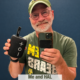 Len Kinzel, the chaplain, holding up his bluetooth speaker.